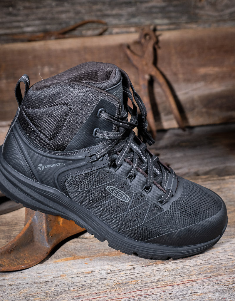 Black hiking boot on a wooden surface