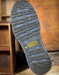 Close-up of a Keen brand shoe sole on a wooden background