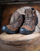 Pair of brown hiking boots on a wooden surface