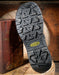 Close-up of a Keen boot sole on a wooden surface