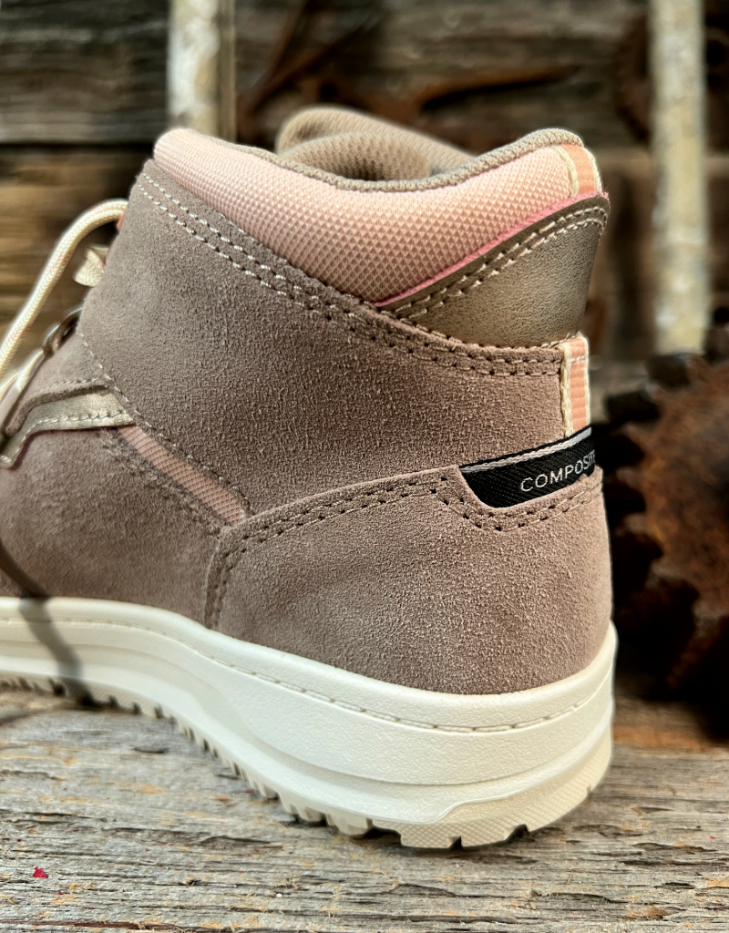 Brown mid top sneaker with pink lining on a wooden surface
