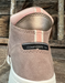 Brown shoe with a composite toe label on a wooden background