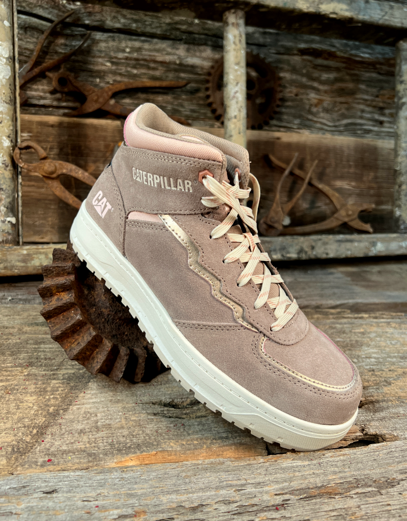 Brown and pink boot with white sole on a rustic wooden background