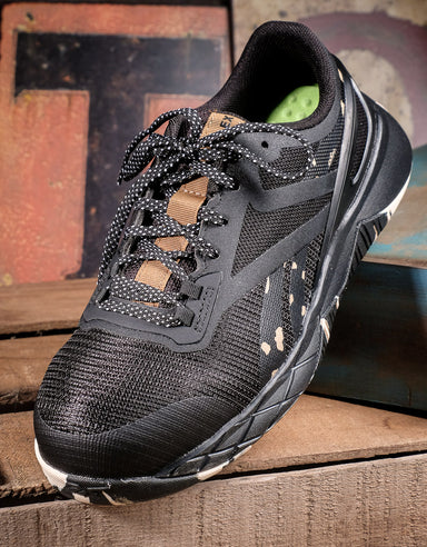 front view of black work shoe sitting on a brown wooden box