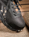 close up of the toe of black athletic shoe 