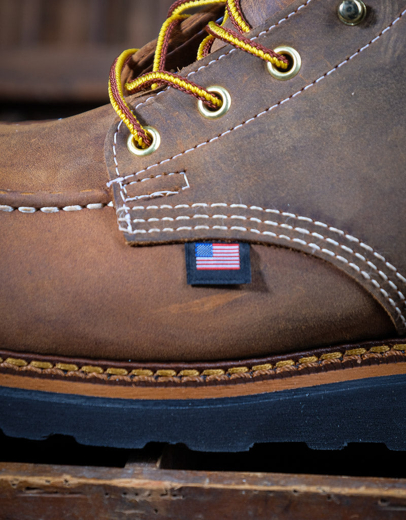 Close-up of a brown leather boot with American flag label