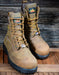 Pair of brown work boots with Thorogood brand labels on a wooden surface
