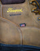 Close-up of a brown leather boot with 'Thorogood' branding and waterproof label. And small American flag label