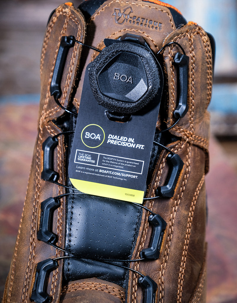 Close-up of a brown boot with BOA system label on a blurred background