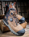 A pair of rugged work boots in brown and black with orange accents, displayed on wooden crates against a rustic dark wood background.