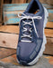 Top view of timberland pro tennis shoe with laced white laces tied in a bow
