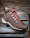 Brown hiking boot with pink laces on a wooden pallet
