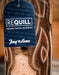 Close-up of a Tony Lama boot with a Requill label on a blurred background