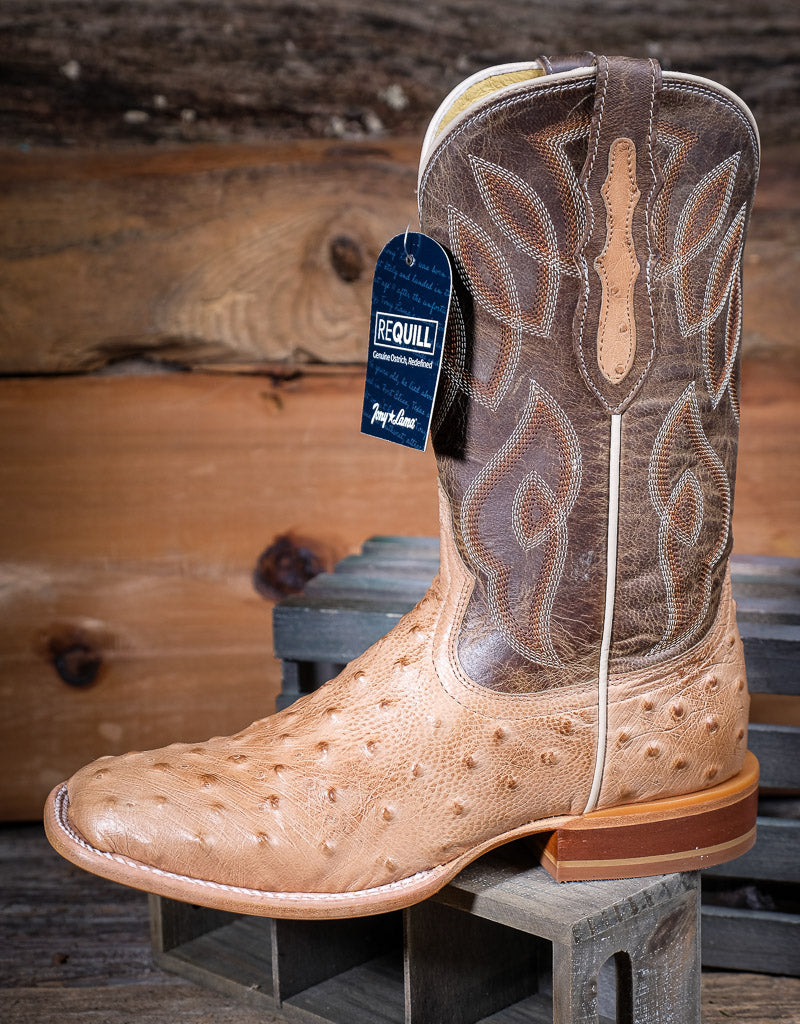Brown and tan cowboy boot with a Requill tag on a wooden background