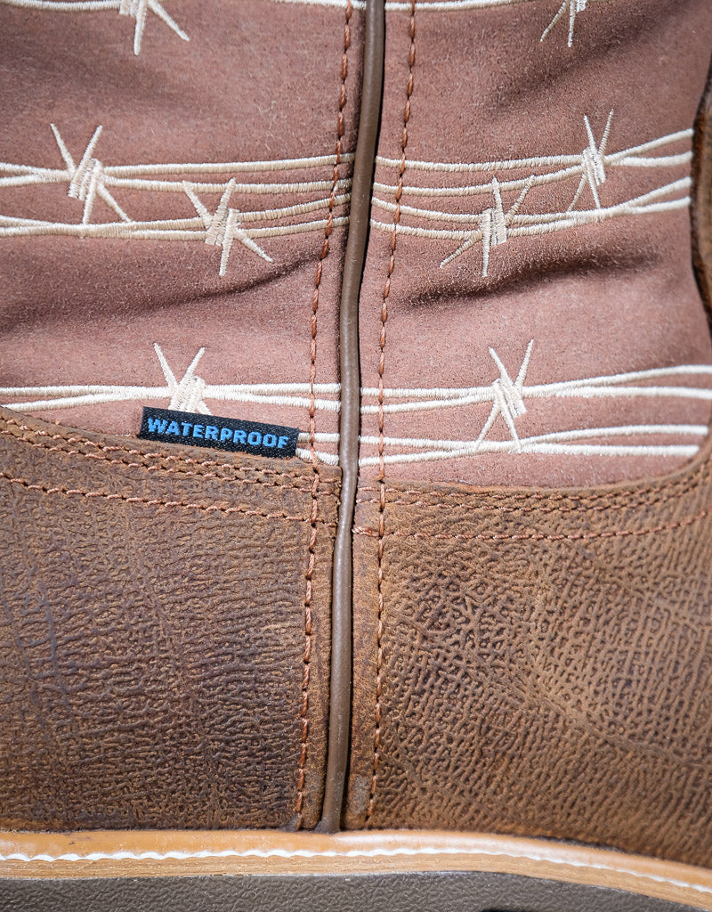 Close-up of a brown leather boot with barbed wire pattern and waterproof label.