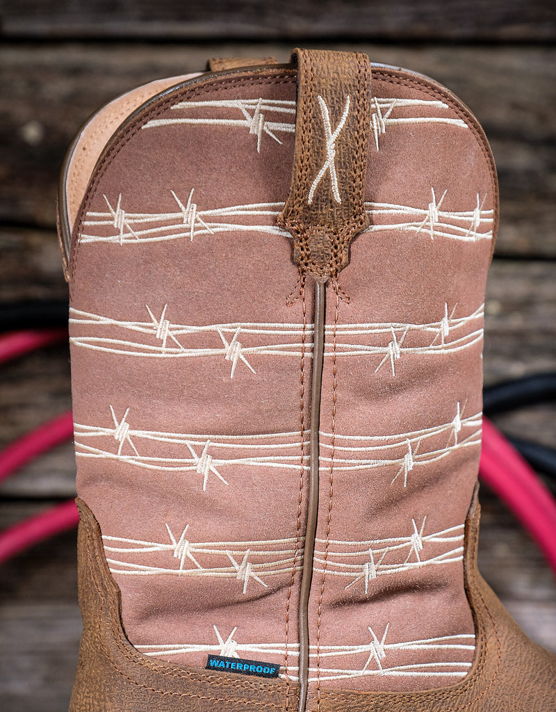 Brown cowboy boot with barbed wire pattern on a wooden background