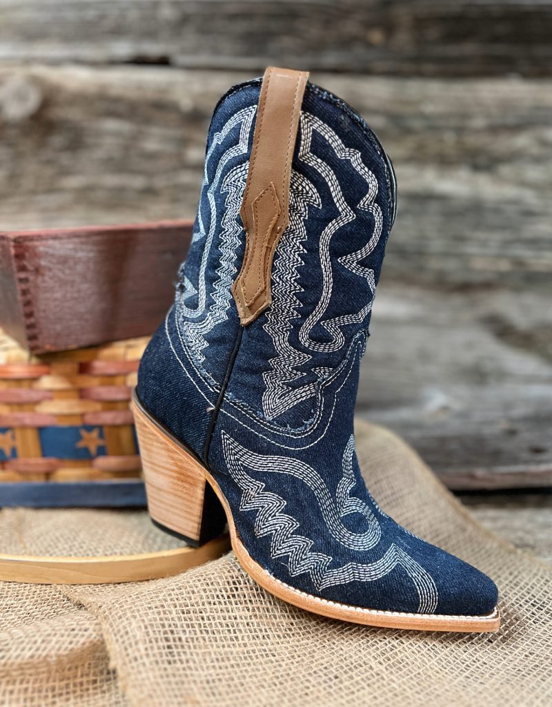 Single pull on blue boot with brown boot pull and a wooden background
