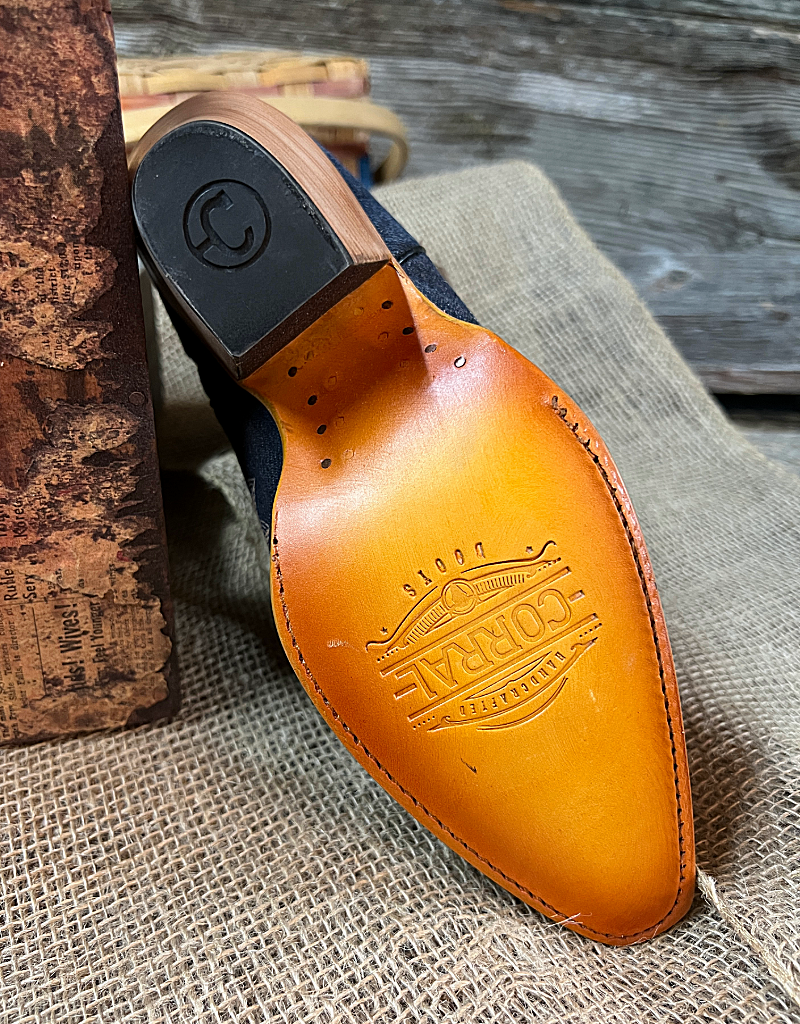 A leather sole and rubber heel cap stamped with the Corral Boots insignia