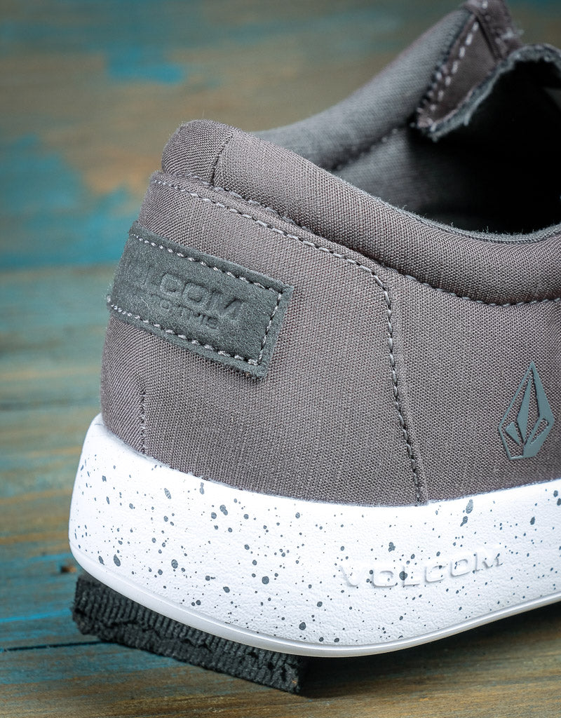 close up on the heel of a shoe. The sole is white and the back features a Volcom brand patch
