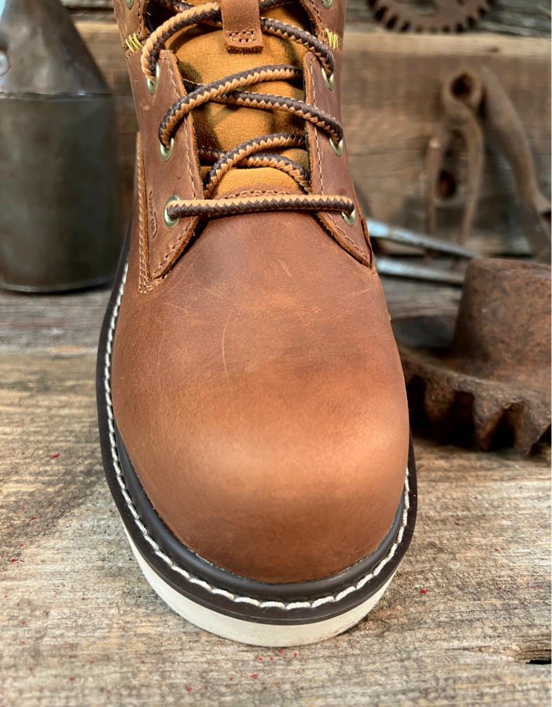 Brown leather boot toe with a white sole on a rustic wooden background