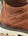 Close-up of a brown Wolverine boot with visible branding and waterproof plus feature.