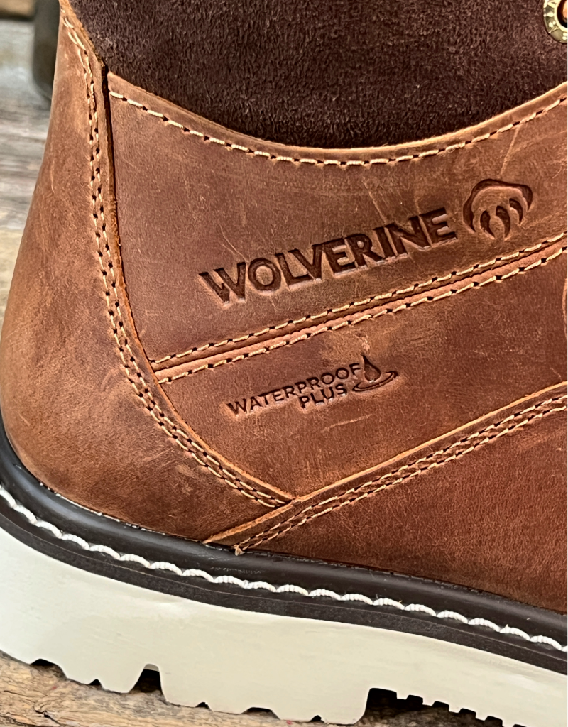Close-up of a brown Wolverine boot with visible branding and waterproof plus feature.