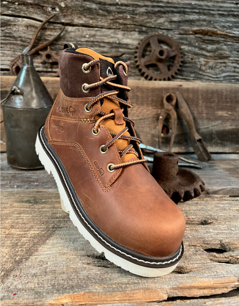 Brown leather boot with white sole on a rustic wooden background