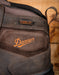Close-up of a Danner boot with visible logo stating 'Danner Dry waterproof' on a wooden background