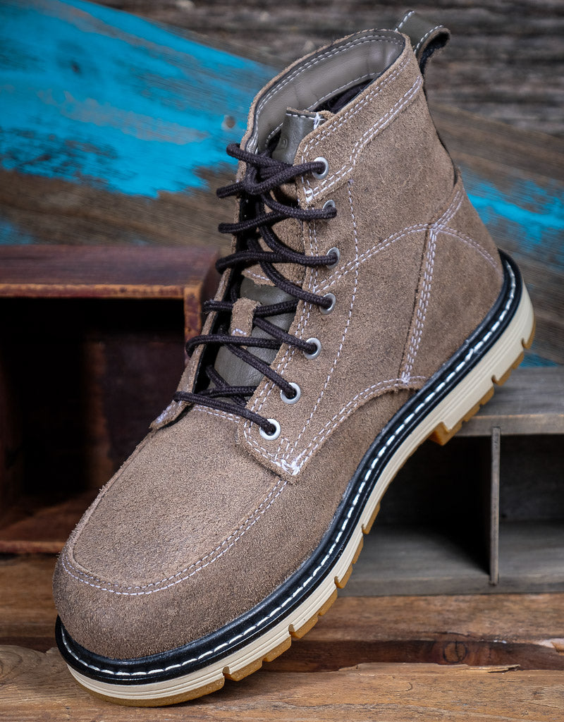 Brown suede boot with black laces on a wooden surface