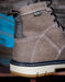 Close-up of a brown boot with visible KeenDry Waterproof logo on a blurred background