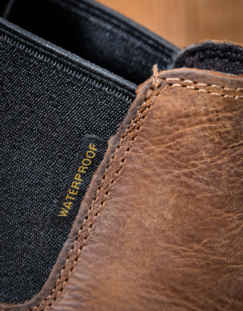 Brown leather boot with waterproof label on black elastic