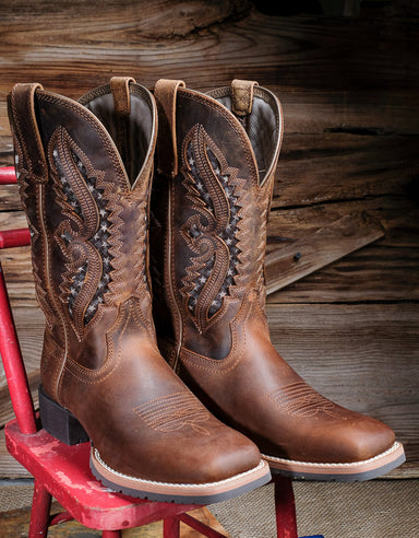 Ariat 10044473 pair of boots with vented tops on top of a red chair