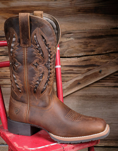 Profile of Ariat cowgirl boot 10044473 on a red chair 