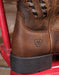 brown leather boot with rubber heel closeup an Ariat label printed on the heel
