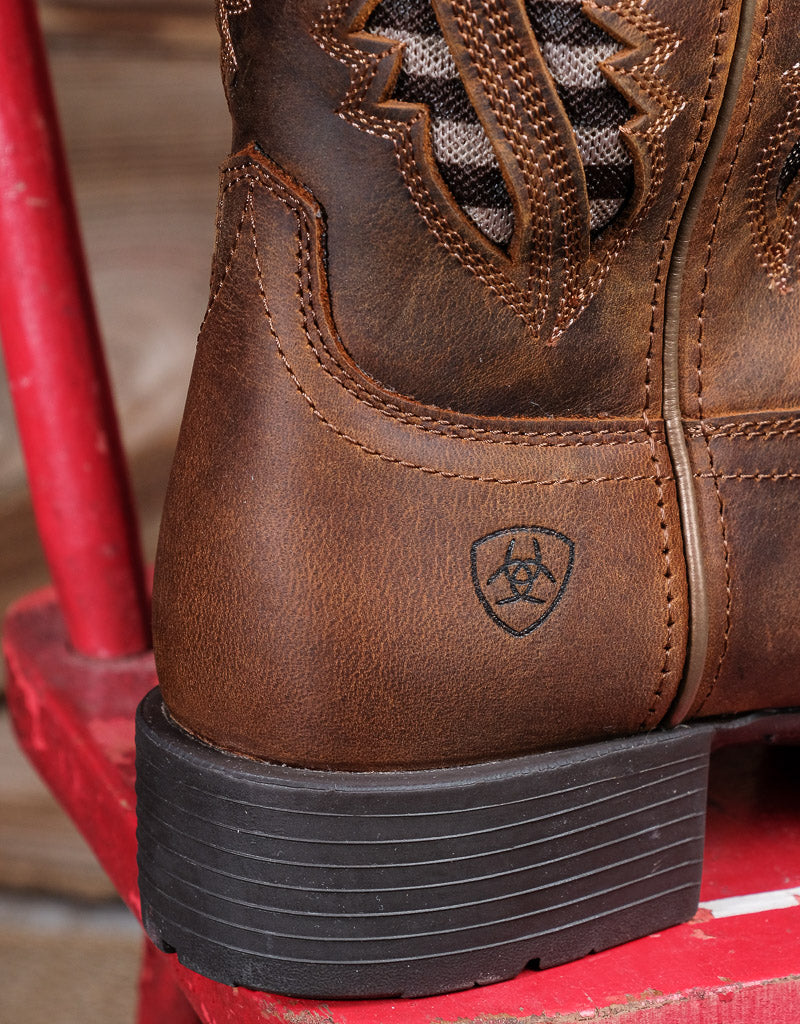 brown leather boot with rubber heel closeup an Ariat label printed on the heel