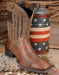 profile of Ariat My Country Cowboy boots with a red white and blue barrel behind