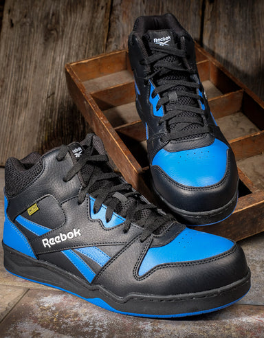 One pair of Reebok black and blue high top athletic met guard shoes on top of small wooden shelves