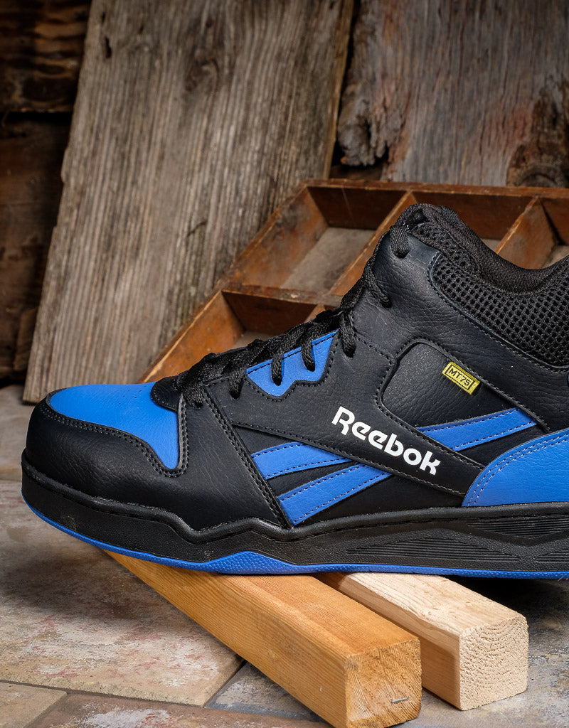 profile view of reebok shoe resting on top of two pieces of wood